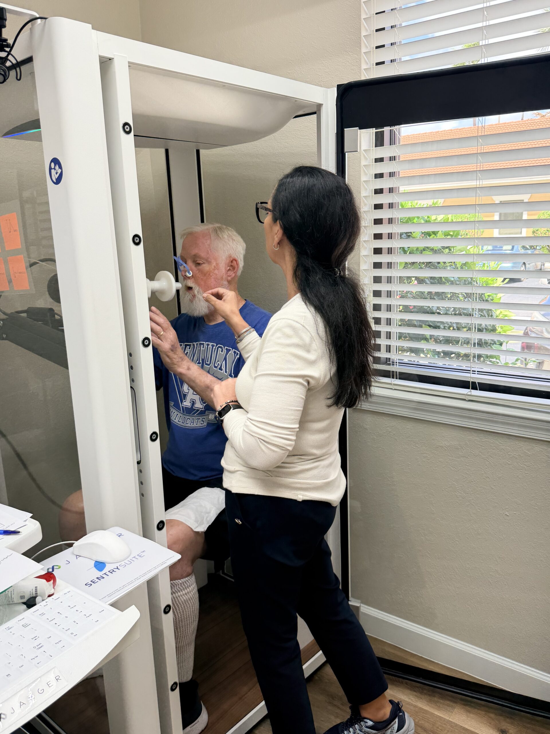 Woman helping a child take a measurement on a height scale.