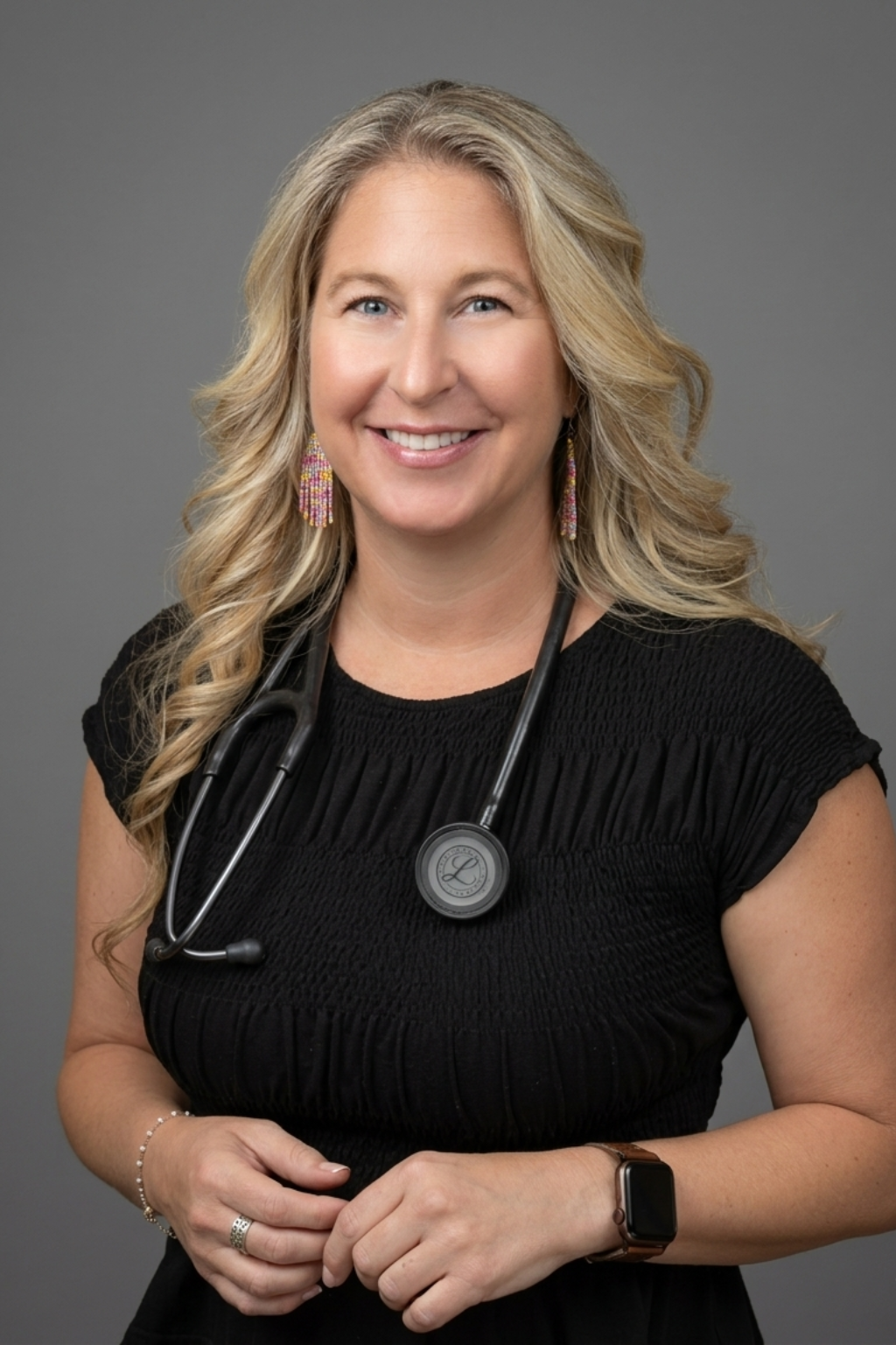 Smiling female doctor with stethoscope around neck.